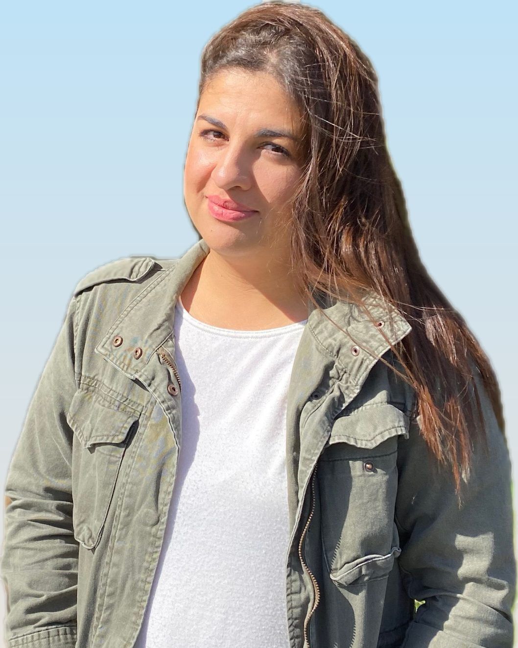 Antonia Robles smiling outdoors in a green jacket, with long brown hair